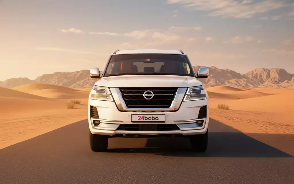 Nissan Patrol 2022 White front view with headlights – rental in Dubai
