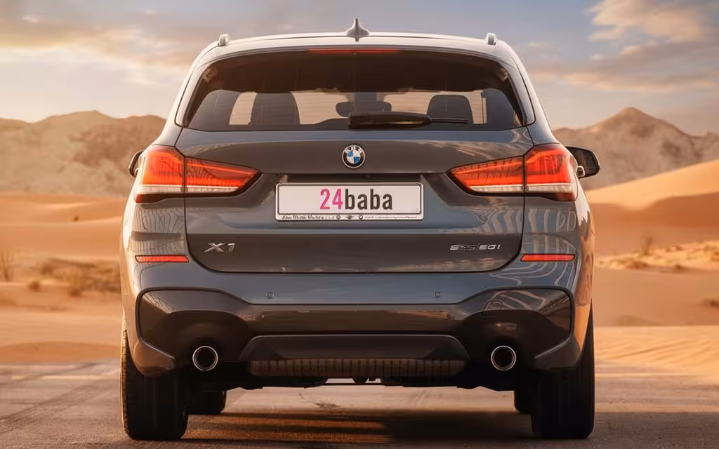 Bmw X1 2021 Blue rear view showing taillights – rental in Dubai